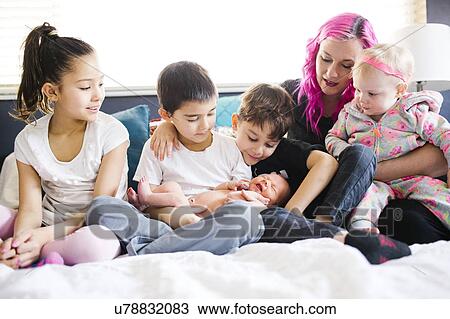 Children (2-3, 6-7, 8-9, 10-11) taking care of baby boy (2-5 months) View Large Photo Image Stock Image - Children (2-3, 6-7, 8-9, 10-11) taking care of baby boy (2-5 months). Fotosearch