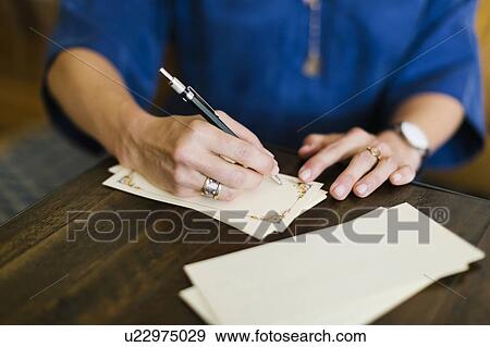 Stock Photo - Close-up of woman writing letter. Fotosearch