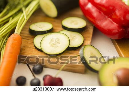 Close-up of zucchini slices on cutting board View Large Photo Image Stock Photo - Close-up of zucchini slices on cutting board. Fotosearch