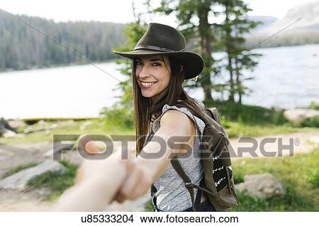 Picture - Couple hiking by lake. Fotosearch