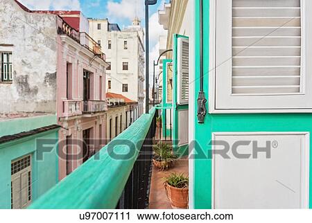 Stock Image - Cuba, Havana, Building terrace with turquoise doors. Fotosearch