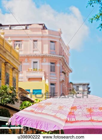 Stock Image - Cuba, Havana, Colonial architecture and sunshade in foreground. Fotosearch