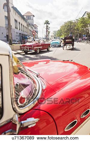 Cuba, Havana, Red vintage car in street View Large Photo Image Stock Photo - Cuba, Havana, Red vintage car in street. Fotosearch