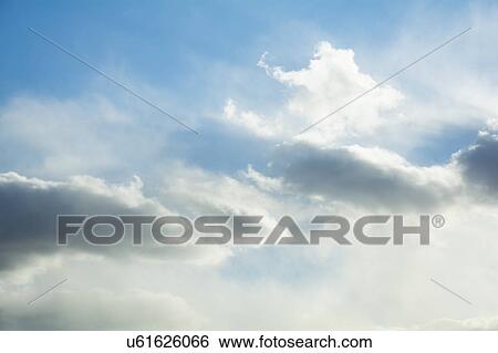 Stock Photograph - Cumulus clouds on sky. Fotosearch