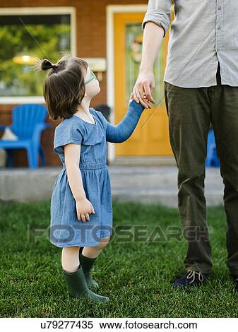 Stock Photography - Daughter (2-3) looking at father. Fotosearch