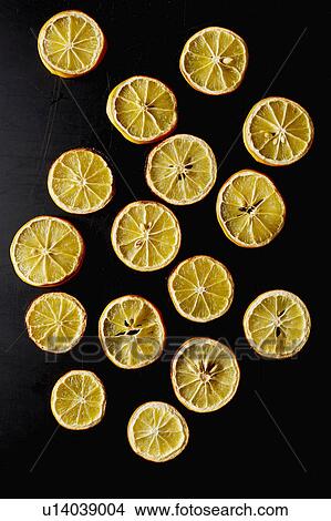 Picture - Dried lemon slices on black background. Fotosearch