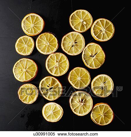 Stock Photography - Dried lemon slices on black background. Fotosearch