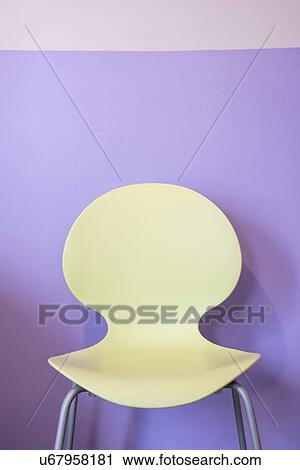 Empty yellow chair by purple wall View Large Photo Image Stock Image - Empty yellow chair by purple wall. Fotosearch