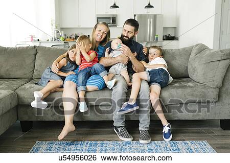 Family with four children (6-11 months, 2-3, 6-7) spending time on sofa View Large Photo Image Stock Photograph - Family with four children (6-11 months, 2-3, 6-7) spending time on sofa. Fotosearch