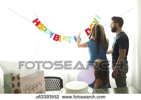 Family with one child (6-7) preparing birthday party View Large Photo Image Stock Image - Family with one child (6-7) preparing birthday party. Fotosearch