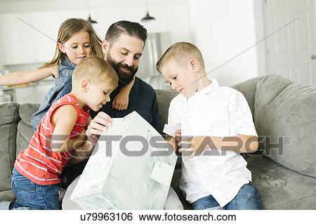 Family with three children (2-3, 6-7) celebrating fathers day View Large Photo Image Stock Photograph - Family with three children (2-3, 6-7) celebrating fathers day. Fotosearch