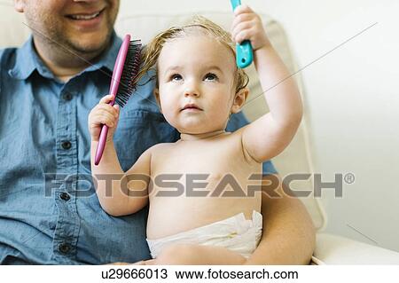 Father and baby girl (12-17 months) brushing hair after bath View Large Photo Image Stock Image - Father and baby girl (12-17 months) brushing hair after bath. Fotosearch