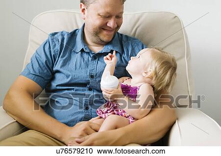 Father feeding baby girl (12-17 months) View Large Photo Image Stock Image - Father feeding baby girl (12-17 months). Fotosearch