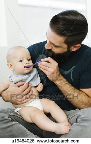 Father feeding son (6-11 months) View Large Photo Image Stock Photograph - Father feeding son (6-11 months). Fotosearch