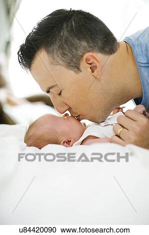 Father kissing daughter (0-1 months) View Large Photo Image Stock Image - Father kissing daughter (0-1 months). Fotosearch