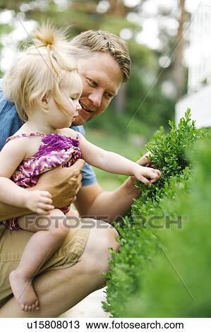 Father playing with baby girl (12-17 months) in backyard View Large Photo Image Stock Image - Father playing with baby girl (12-17 months) in backyard. Fotosearch