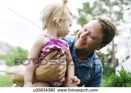 Father playing with baby girl (12-17 months) in backyard View Large Photo Image Stock Image - Father playing with baby girl (12-17 months) in backyard. Fotosearch
