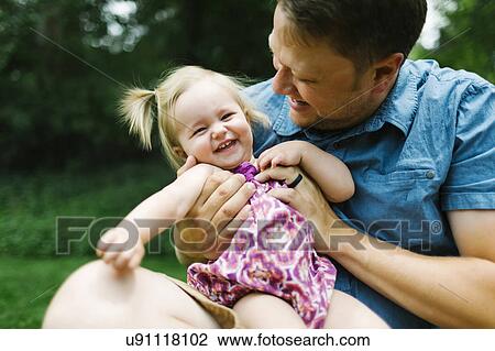 Father playing with baby girl (12-17 months) in backyard View Large Photo Image Stock Image - Father playing with baby girl (12-17 months) in backyard. Fotosearch