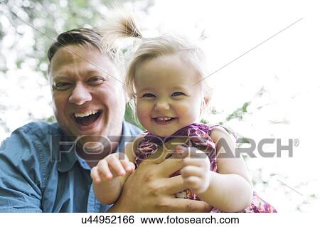 Father playing with baby girl (12-17 months) in backyard View Large Photo Image Stock Photograph - Father playing with baby girl (12-17 months) in backyard. Fotosearch