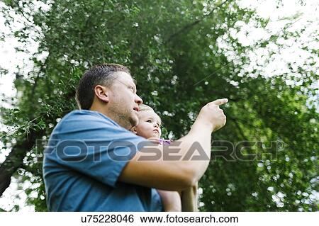 Father playing with baby girl (12-17 months) in backyard View Large Photo Image Stock Photograph - Father playing with baby girl (12-17 months) in backyard. Fotosearch