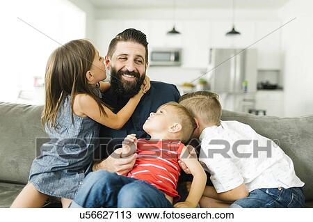 Stock Image - Father playing with three children (2-3, 6-7). Fotosearch