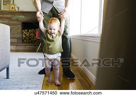 Father walking with daughter (12-17 months) View Large Photo Image Stock Image - Father walking with daughter (12-17 months). Fotosearch