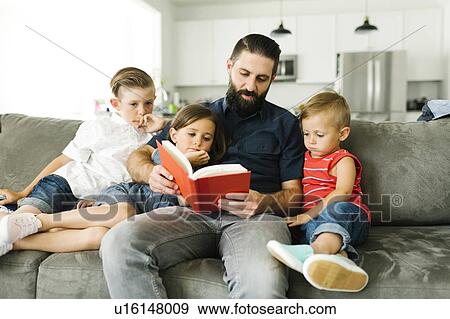 Father with his three children (2-3, 6-7) reading book View Large Photo Image Stock Photo - Father with his three children (2-3, 6-7) reading book. Fotosearch