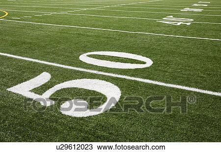Stock Image - Football field marking of 50 yard line. Fotosearch