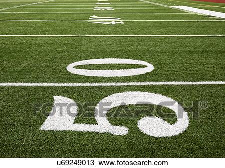 Stock Image - Football field marking of 50 yard line. Fotosearch