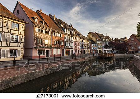 Stock Image - France, Grand Est, Colmar, Sky reflecting in water surface. Fotosearch