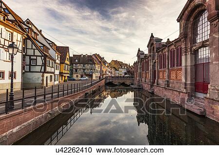 Stock Image - France, Grand Est, Colmar, Sky reflecting in water surface. Fotosearch