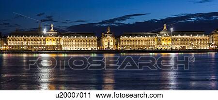 Stock Image - France, Nouvelle-Aquitaine, Bordeaux, Place de la Bourse across Garonne River at night. Fotosearch