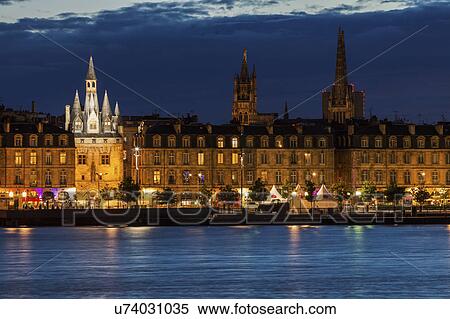 Stock Photography - France, Nouvelle-Aquitaine, Bordeaux, Illuminated Cailhau Gate at night. Fotosearch