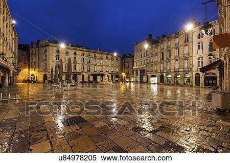 Stock Photography - France, Nouvelle-Aquitaine, Bordeaux, Wet Parliament Square at night. Fotosearch