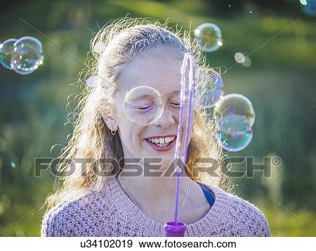 Girl (12-13) blowing bubbles View Large Photo Image Stock Photo - Girl (12-13) blowing bubbles. Fotosearch