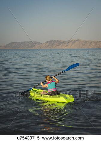 Girl (4-5) kayaking on lake View Large Photo Image Stock Photography - Girl (4-5) kayaking on lake. Fotosearch