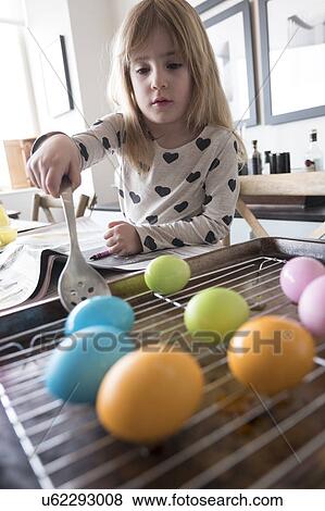 Girl (4-5) making colored Easter eggs View Large Photo Image Stock Photo - Girl (4-5) making colored Easter eggs. Fotosearch