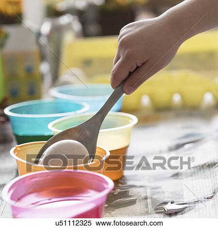 Girl (4-5) making colored Easter eggs View Large Photo Image Stock Photography - Girl (4-5) making colored Easter eggs. Fotosearch