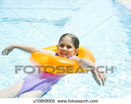 Girl (4-5) swimming in inflatable ring View Large Photo Image Stock Photography - Girl (4-5) swimming in inflatable ring. Fotosearch