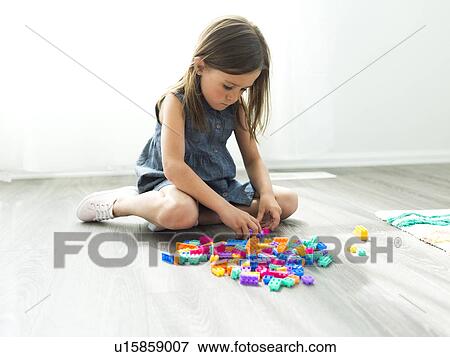 Girl (6-7) playing with plastic blocks View Large Photo Image Stock Photo - Girl (6-7) playing with plastic blocks. Fotosearch