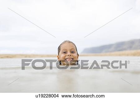 Picture - Girl (6-7) swimming in sea. Fotosearch