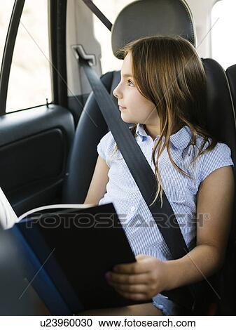 Girl ( 8-9) sitting in car and looking through window View Large Photo Image Stock Image - Girl ( 8-9) sitting in car and looking through window. Fotosearch
