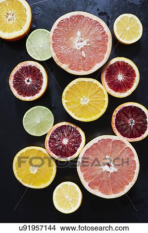 Halved fruits on black background View Large Photo Image Picture - Halved fruits on black background. Fotosearch