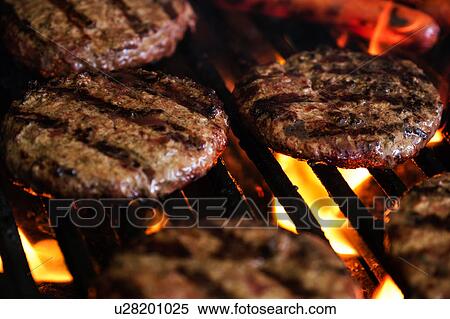 Stock Photography - Hamburgers and hot dog on barbeque grill. Fotosearch