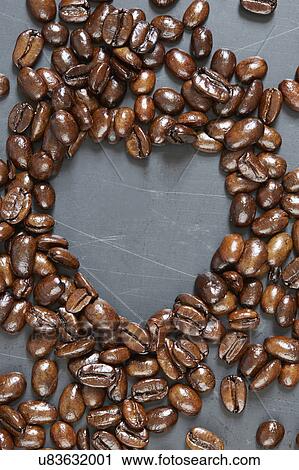 Stock Image - Heart shape made of roasted coffee beans. Fotosearch