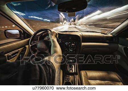 Interior of car driving through city streets at dusk View Large Photo Image Stock Image - Interior of car driving through city streets at dusk. Fotosearch