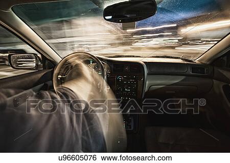 Interior of car driving through city streets at dusk View Large Photo Image Stock Photograph - Interior of car driving through city streets at dusk. Fotosearch
