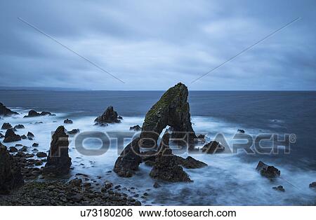 Stock Photograph - Ireland, County Donegal, Crophy Head rock formation in sea. Fotosearch