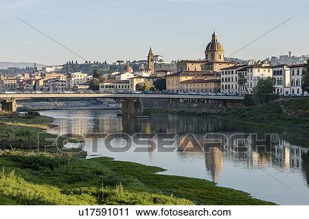 Stock Image - Italy, Tuscany, Florence, Cityscape reflected in Arno river. Fotosearch