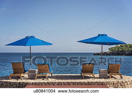 Jamaica, Negril, Beach umbrellas and lounge chairs against tranquil seascape View Large Photo Image Picture - Jamaica, Negril, Beach umbrellas and lounge chairs against tranquil seascape. Fotosearch
